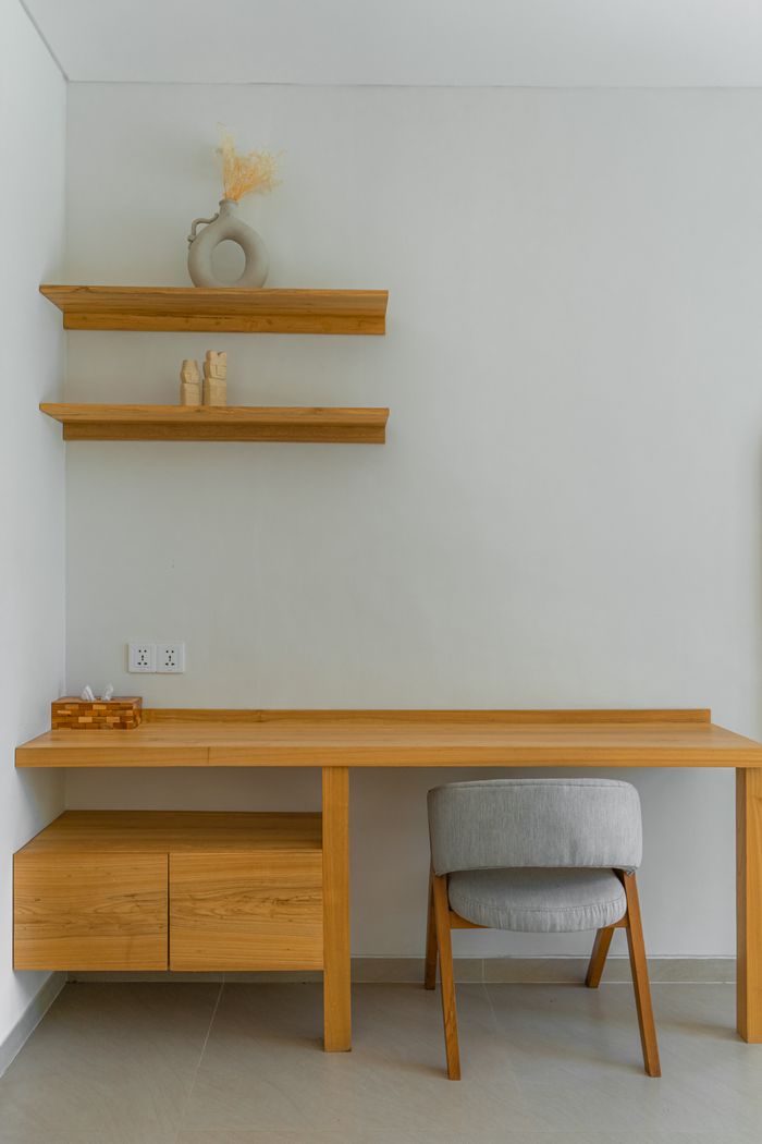Simple and elegant wooden desk setup in a modern minimalist room.
