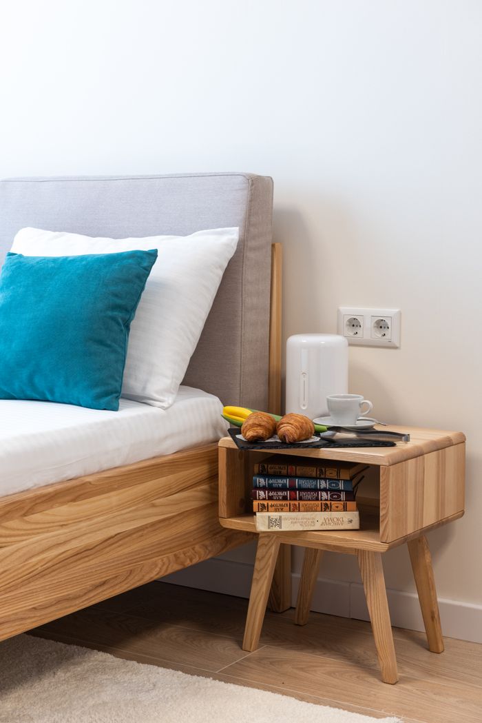 contact-img Croissant with cup of hot drink placed with tulip on bedside table for breakfast on 8 March morning